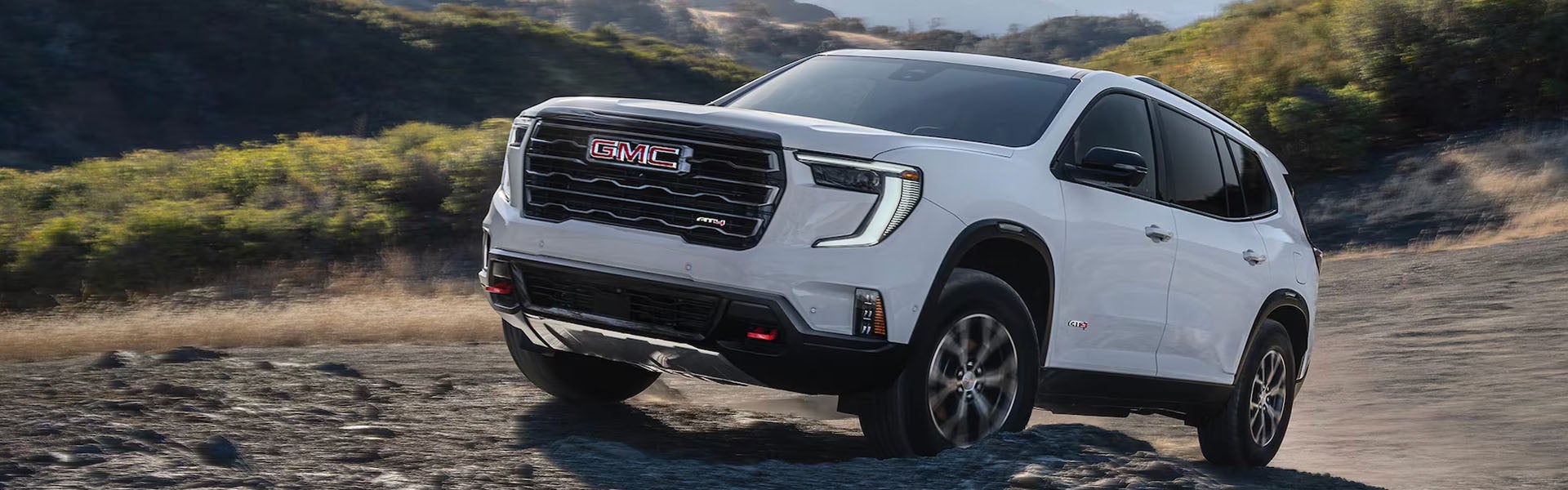 GMC Acadia in motion on a rocky trail