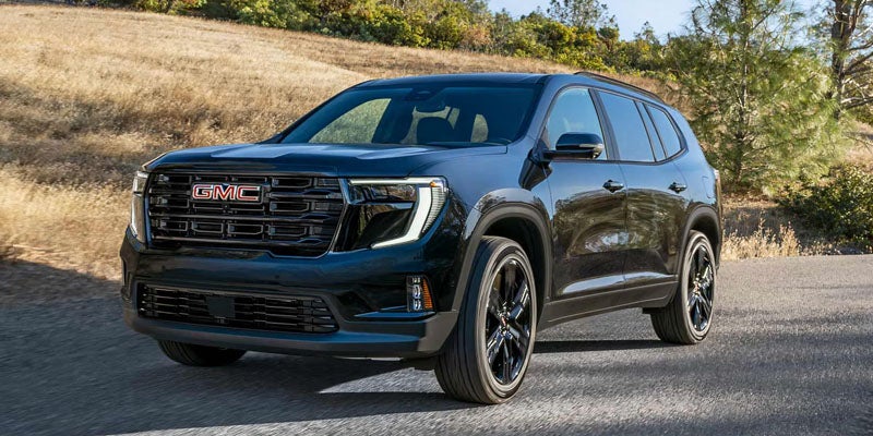 GMC Acadia driving on a scenic road